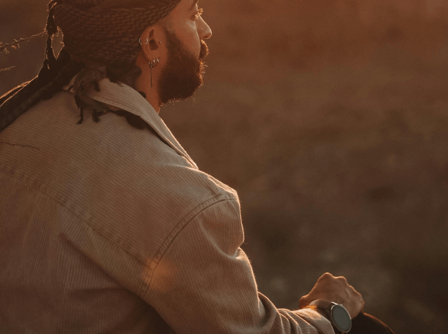 Person sitting in warm evening light, reflecting quietly, symbolising awareness and emotional healing.