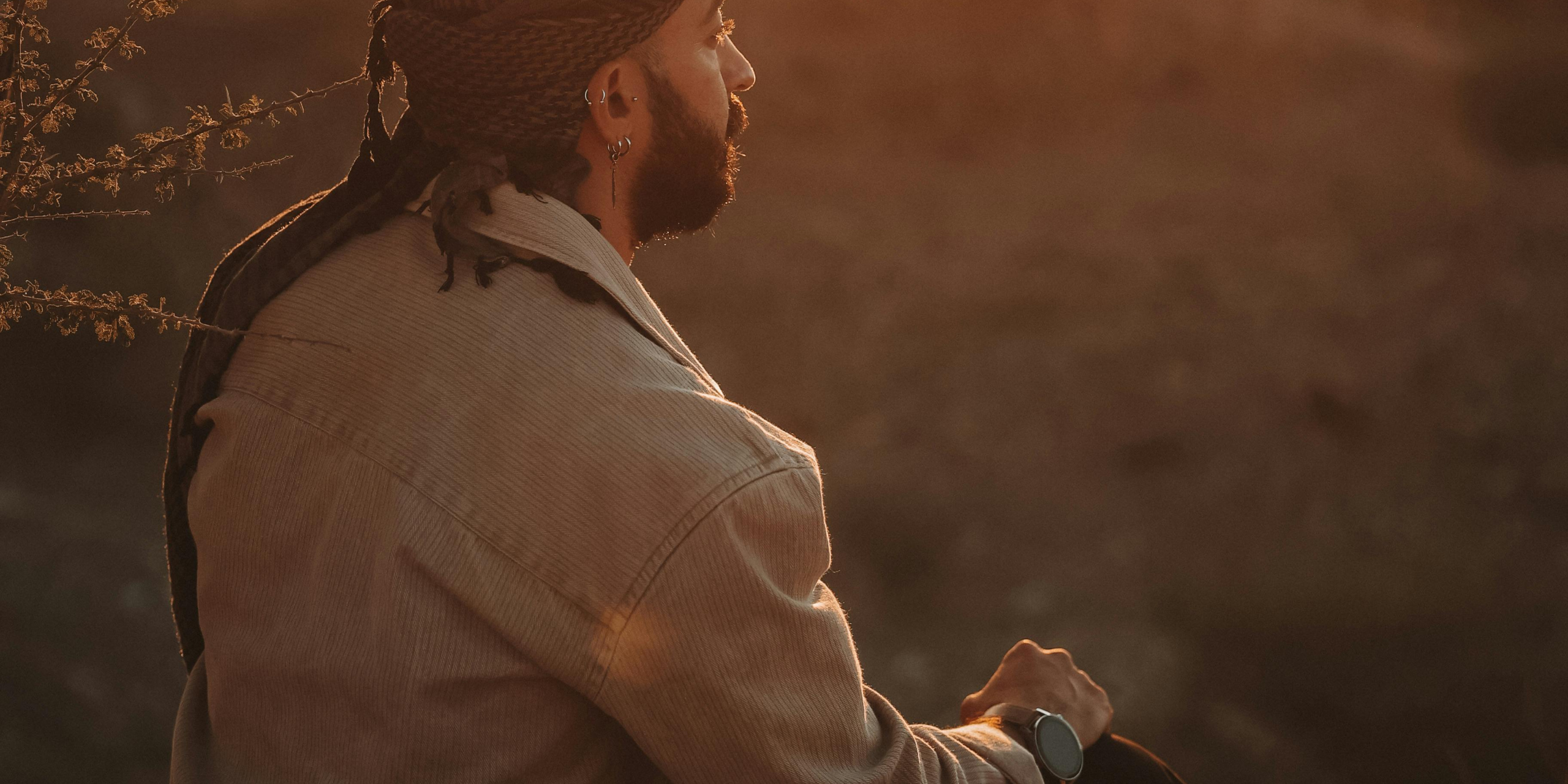 Person sitting in warm evening light, reflecting quietly, symbolising awareness and emotional healing.